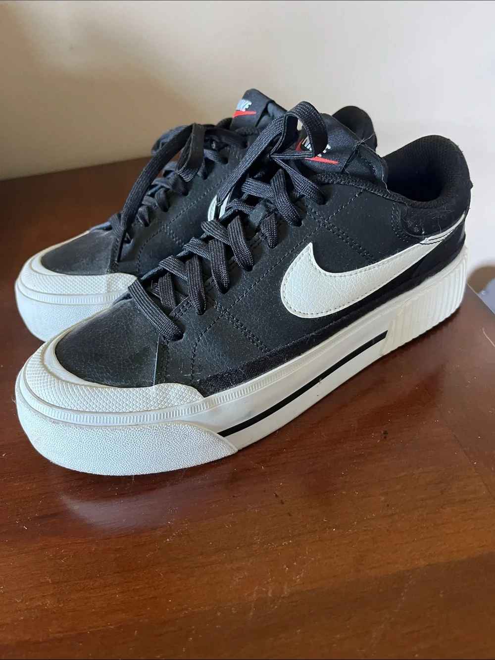 Nike Women’s Black Sneakers with White Swoosh and Red Tongue Logo